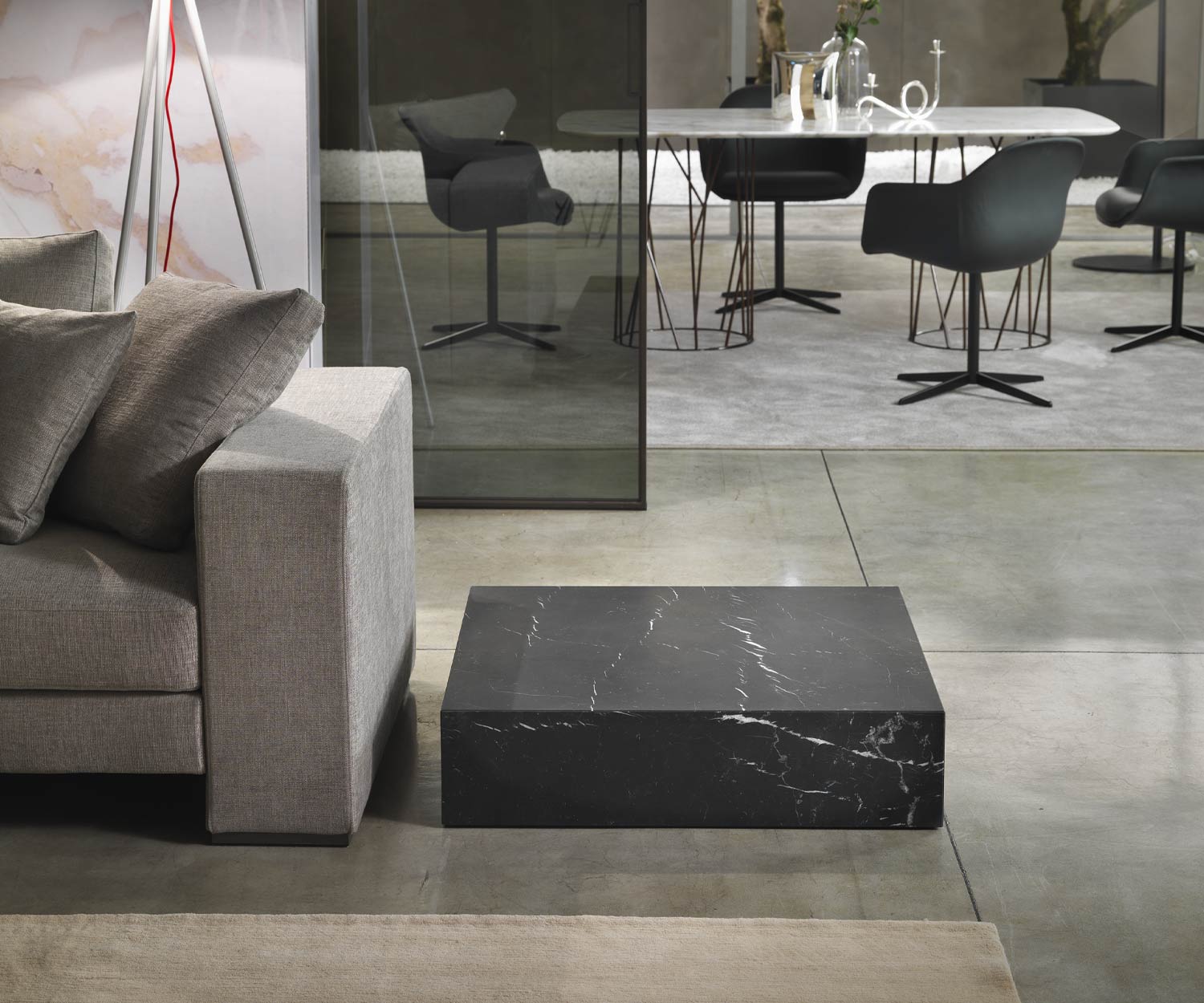 Table basse noire Thor de Marelli au sol sans socle à côté du canapé Table basse noire Thor de Marelli au sol sans socle à côté du canapé